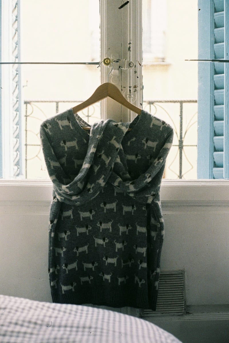 A dress on a hanger by a window