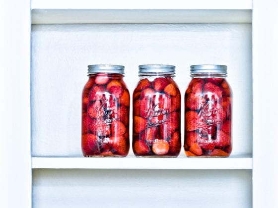 An image of a shelf of jars of fruit
