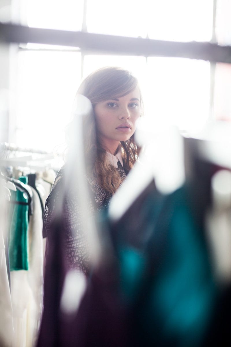 A woman looking through a clothing rack
