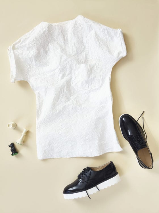 A t-shirt and and sneakers laid out on the floor