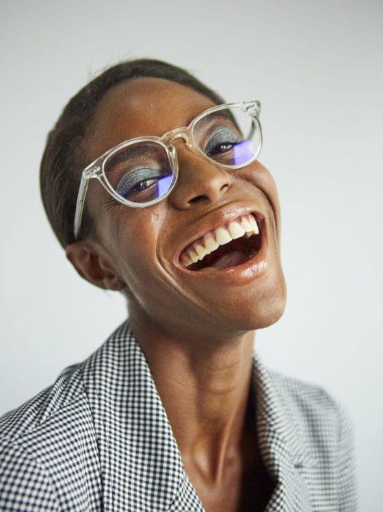 A woman with glasses smiling