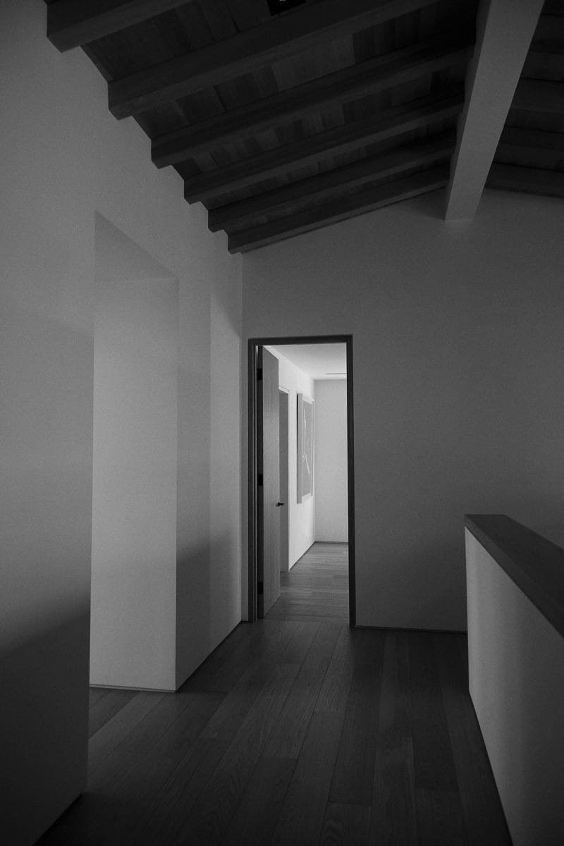 A dark hallway with an open door