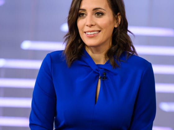 A smiling woman at a news desk