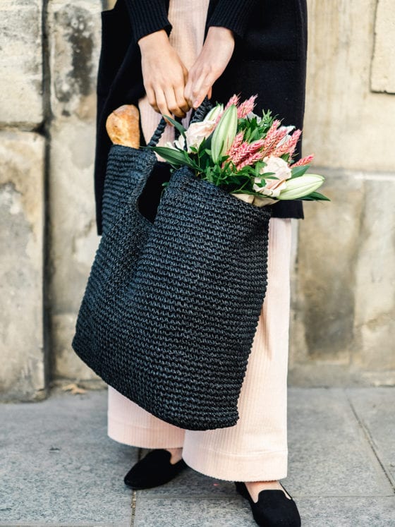 A picture of a woman holding a bag of flowers