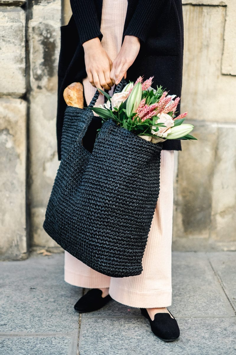 A picture of a woman holding a bag of flowers