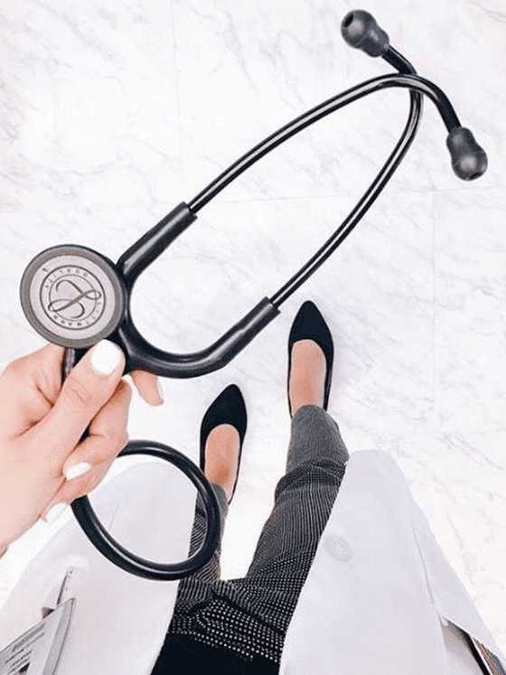 A picture of a woman's hand holding a stethoscope