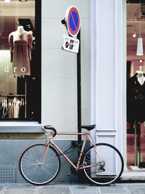 A picture of a bike outside a store window