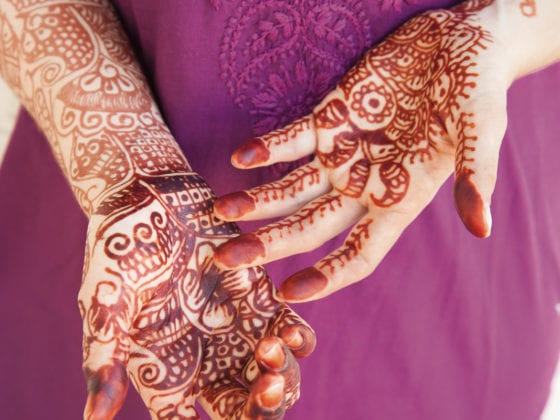 A woman with henna tattoos on her hands