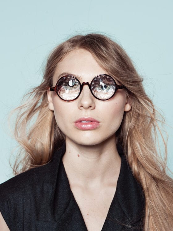 A woman wearing glasses that magnify her eyeballs
