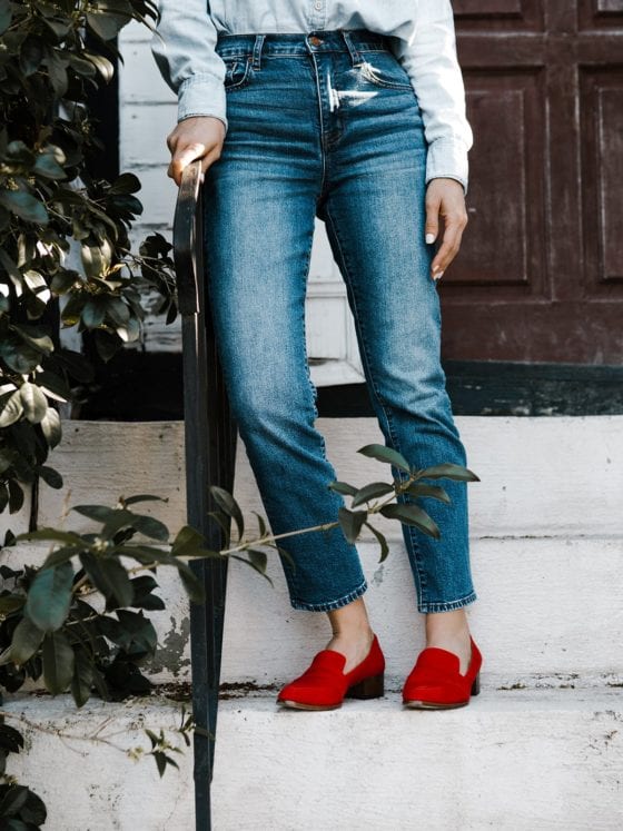A close up of a woman in red shoes on steps