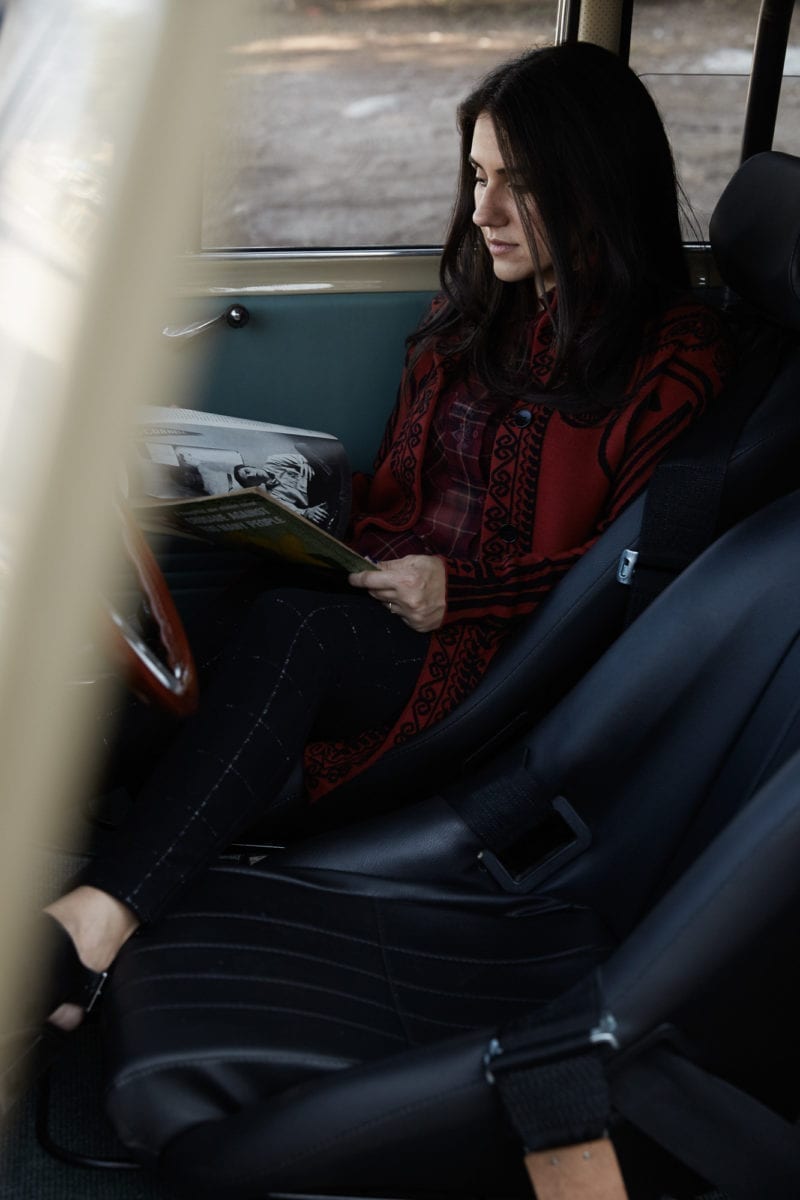 A woman reading in a car