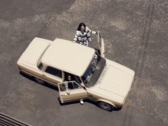 An aerial view of two women getting out of a car