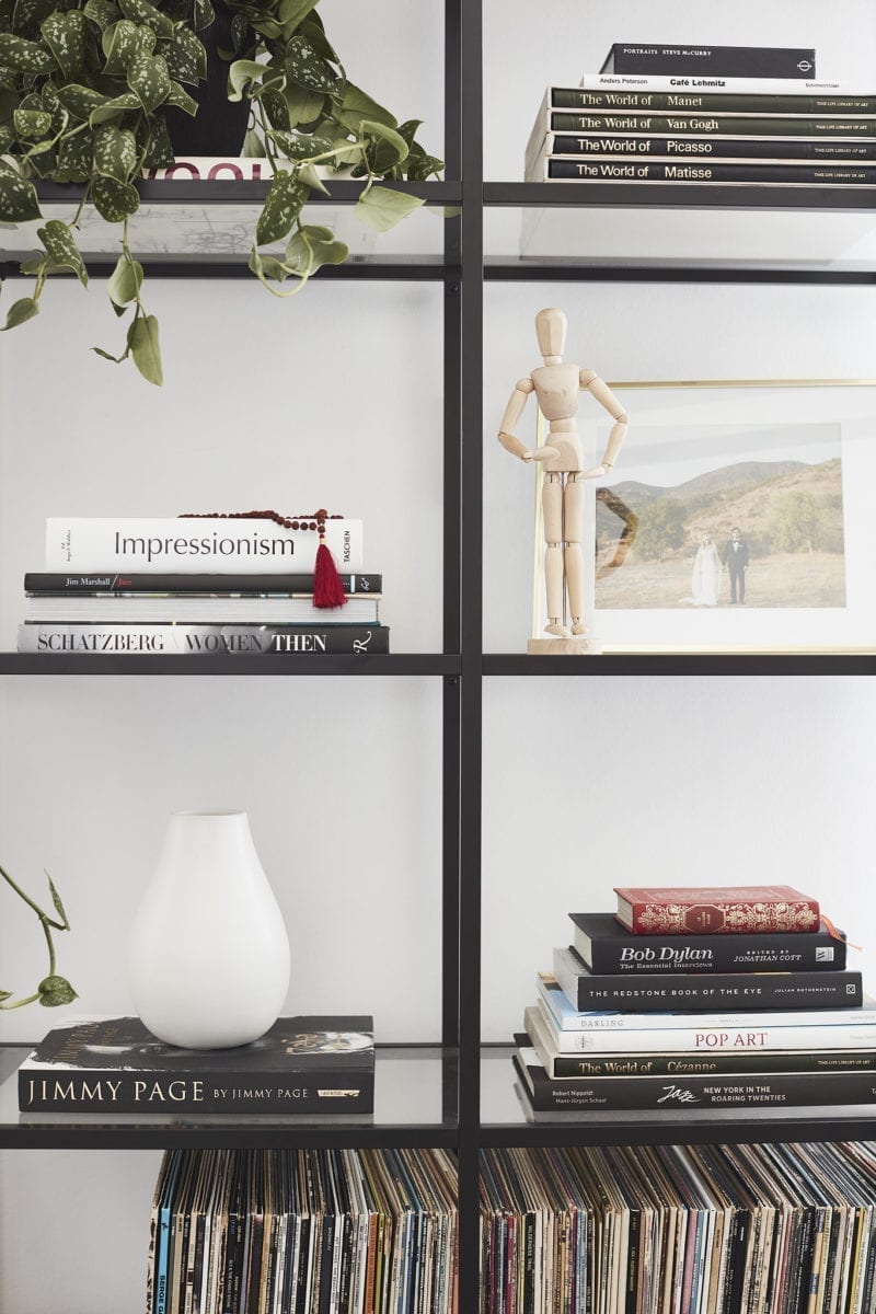 A bookshelf with books and magazines