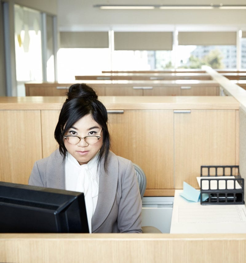 A woman seated at an office desk