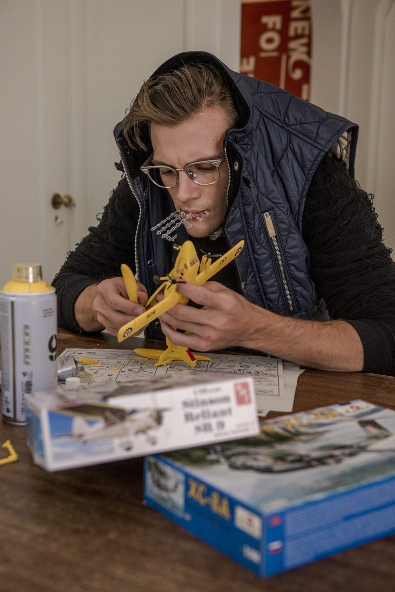 A man at a table with measuring tape and rulers