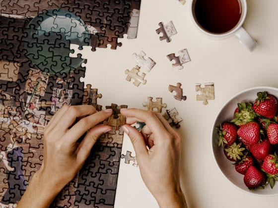 A woman's hands as she puts together a puzzle
