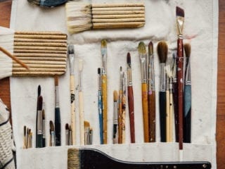 Paint brushes flat on a table